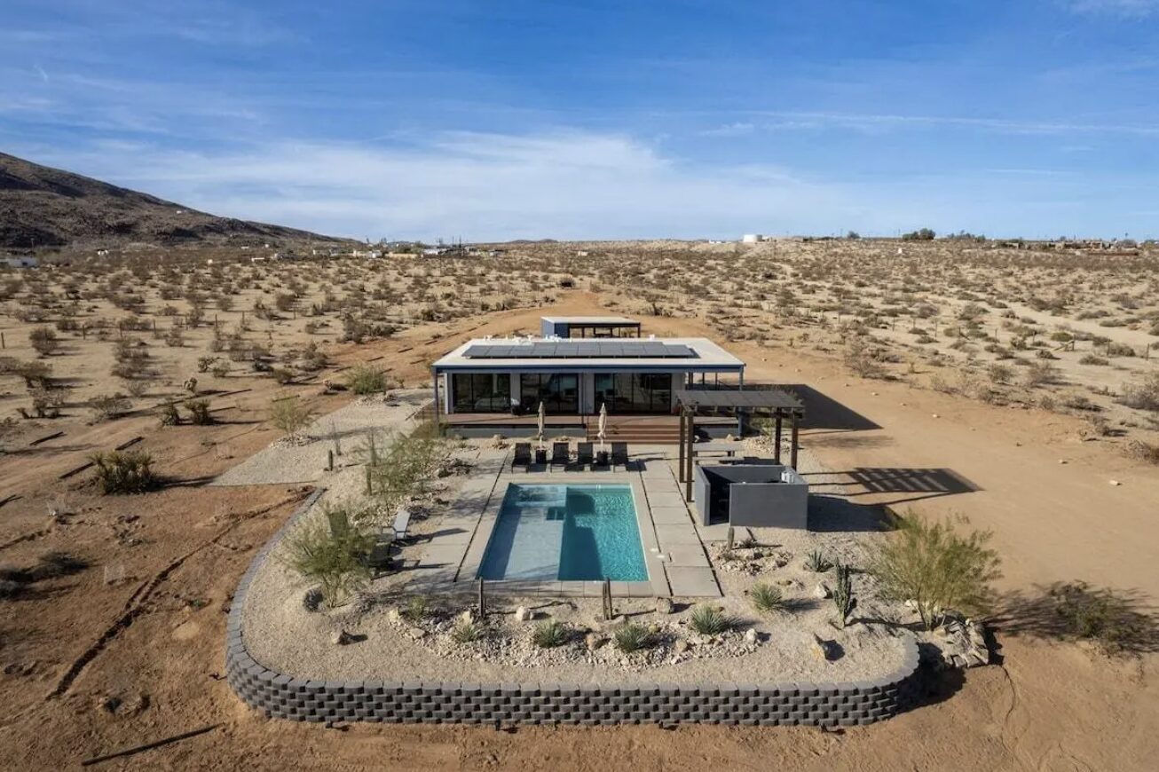 Aerial view of Casa Del Rio, a modern desert home with a pool and landscaped grounds